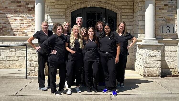 Team photo of dental team in Denton, TX